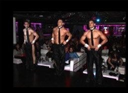 Male strippers without shirts on stage with ties. Sexy businessmen.